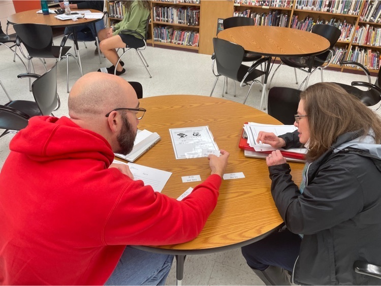 Two CHS teachers work on a sorting activity  