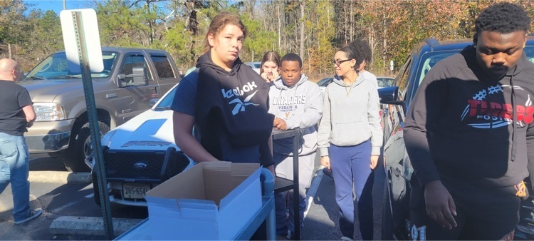 Students help fill up a truck to take food to the King and Queen food bank