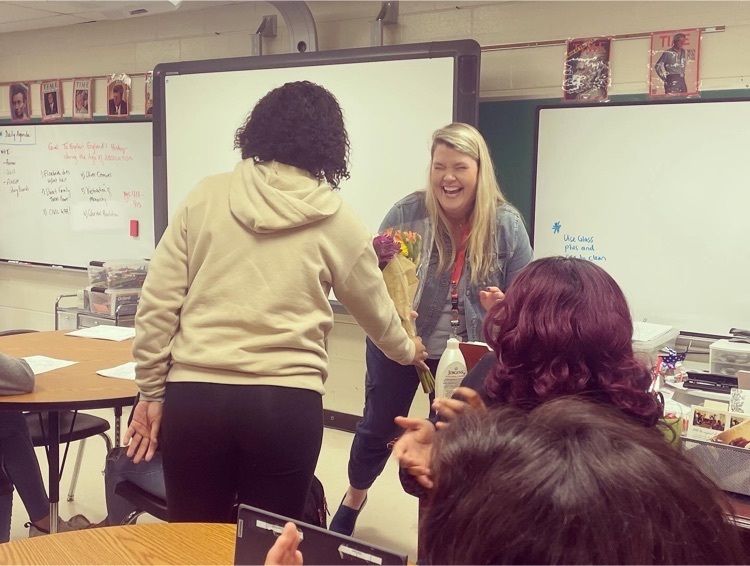 Student, Makayla Holmes, hands Mrs. Holmes a bouquet for winning Teacher of the Year  